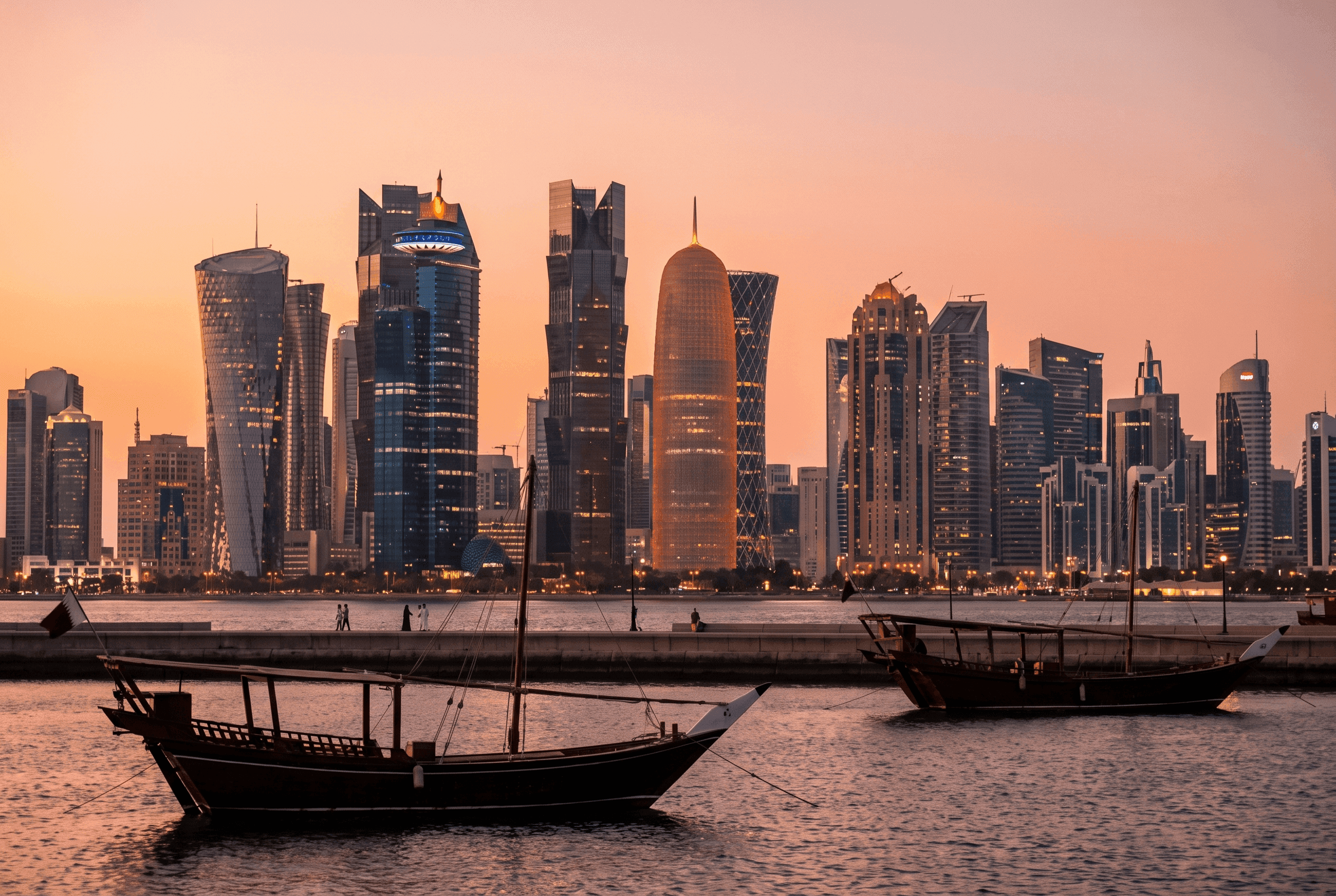 Doha Corniche skyline at sunset with traditional dhow boats