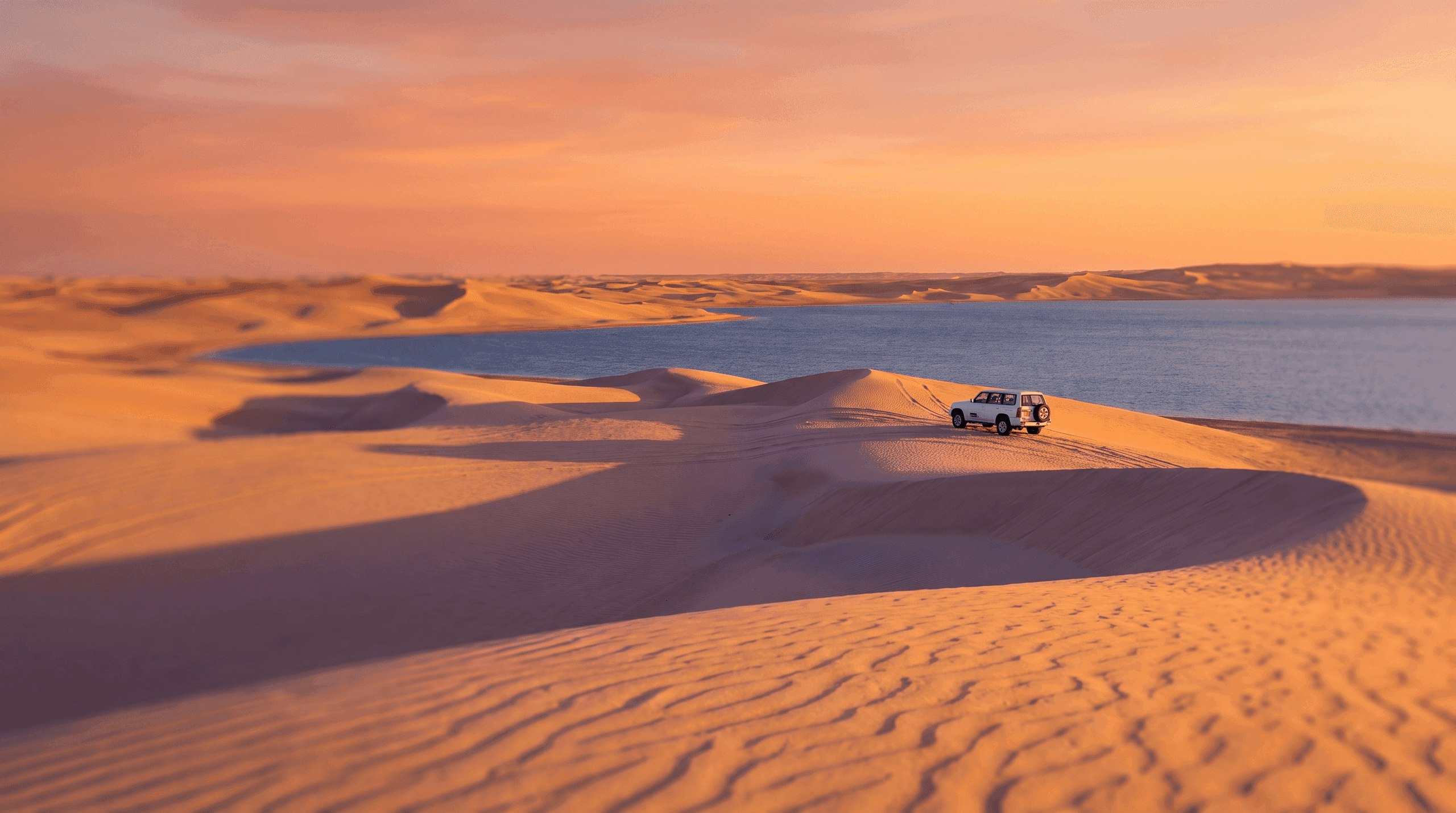 Sunset over the sand dunes and Inland Sea at Khor Al Adaid in southern Qatar